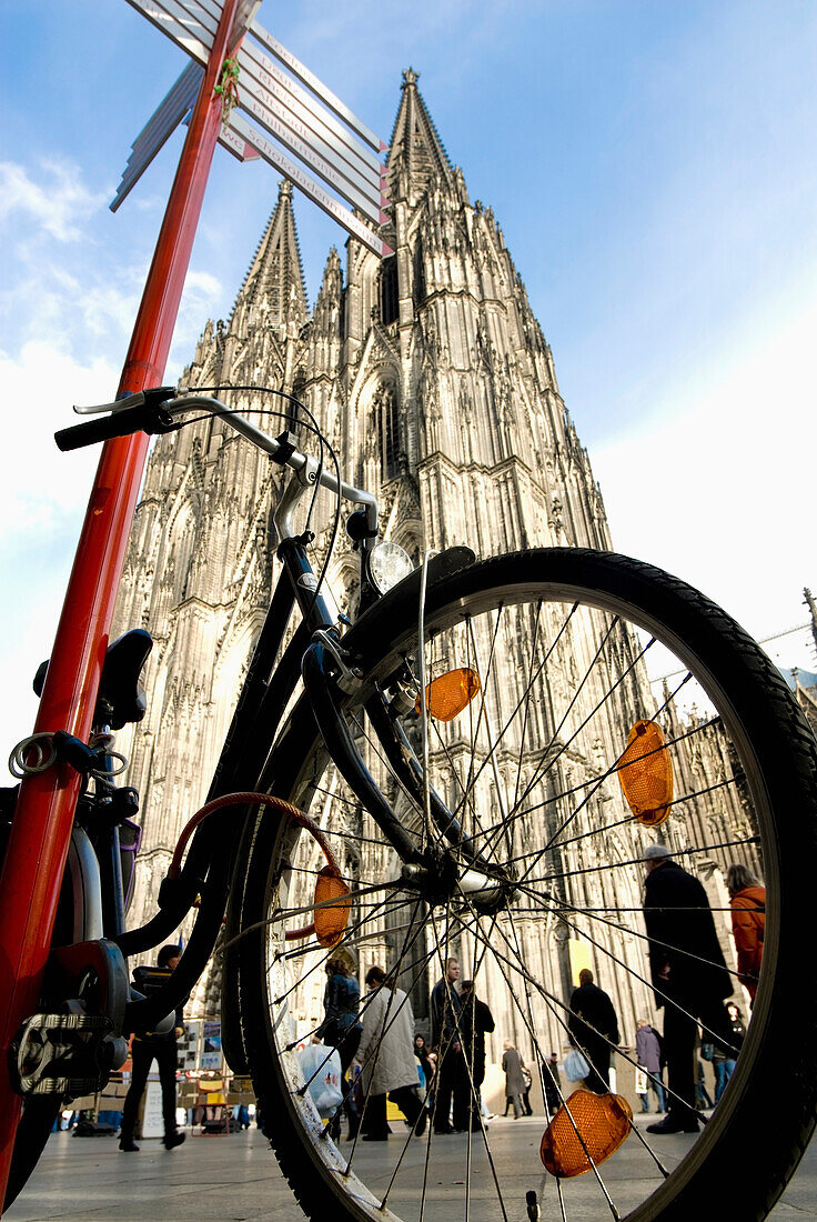 Bicycle Parked By Road Sign Near Cologne Cathedral,Low Angle View, Cologne,Germany