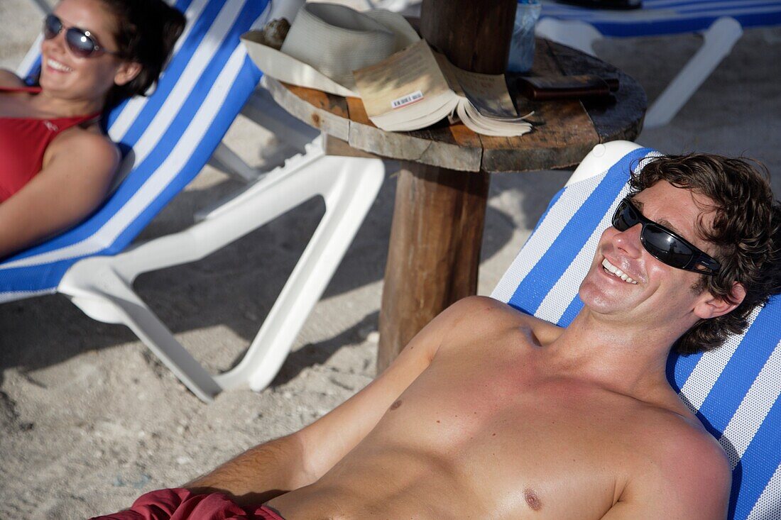 Young Couple Sunbathing On Beach, Mayan Riviera,Yucatan Peninsular,Quintana Roo State,Mexico