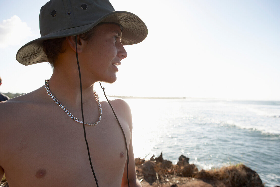 Young Man In Hat Looking At Sea From Shore, British Surfer Josh Hughes In Tanzania,East Africa