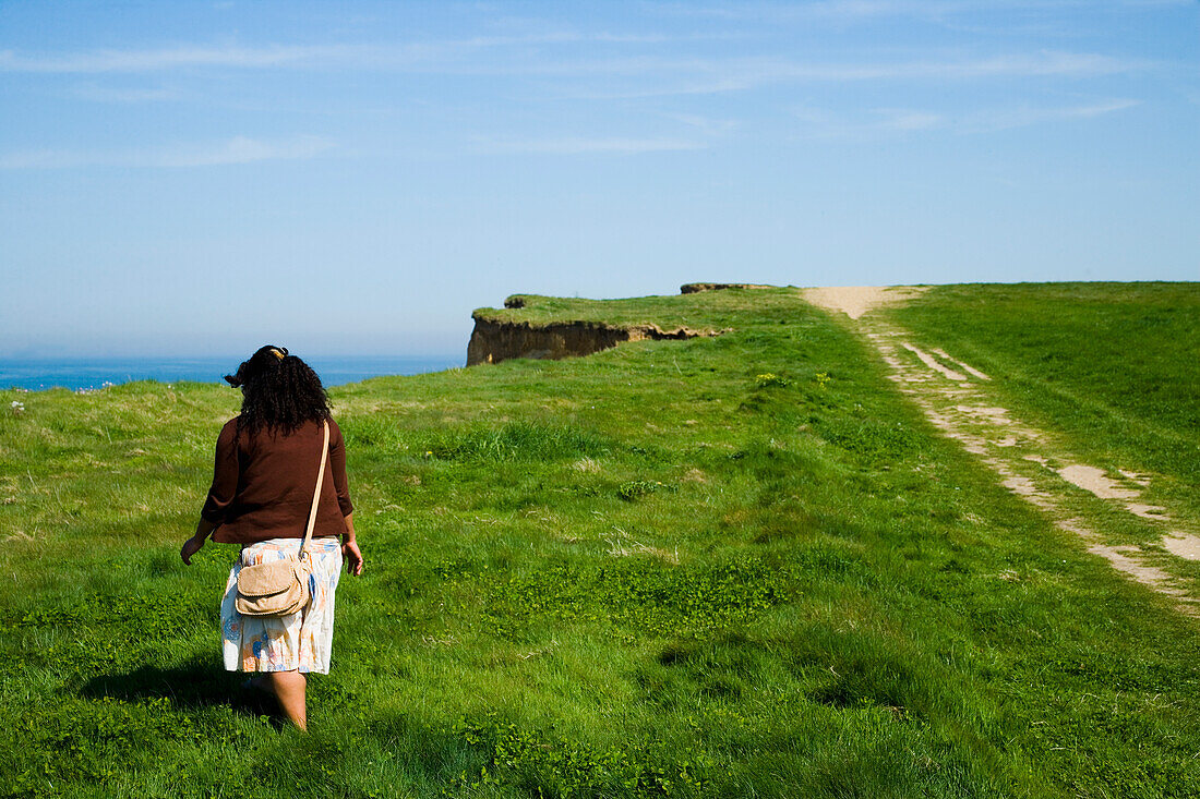 Woman Walking Along Cliff,Rear View, Weybourne,Norfolk,Uk