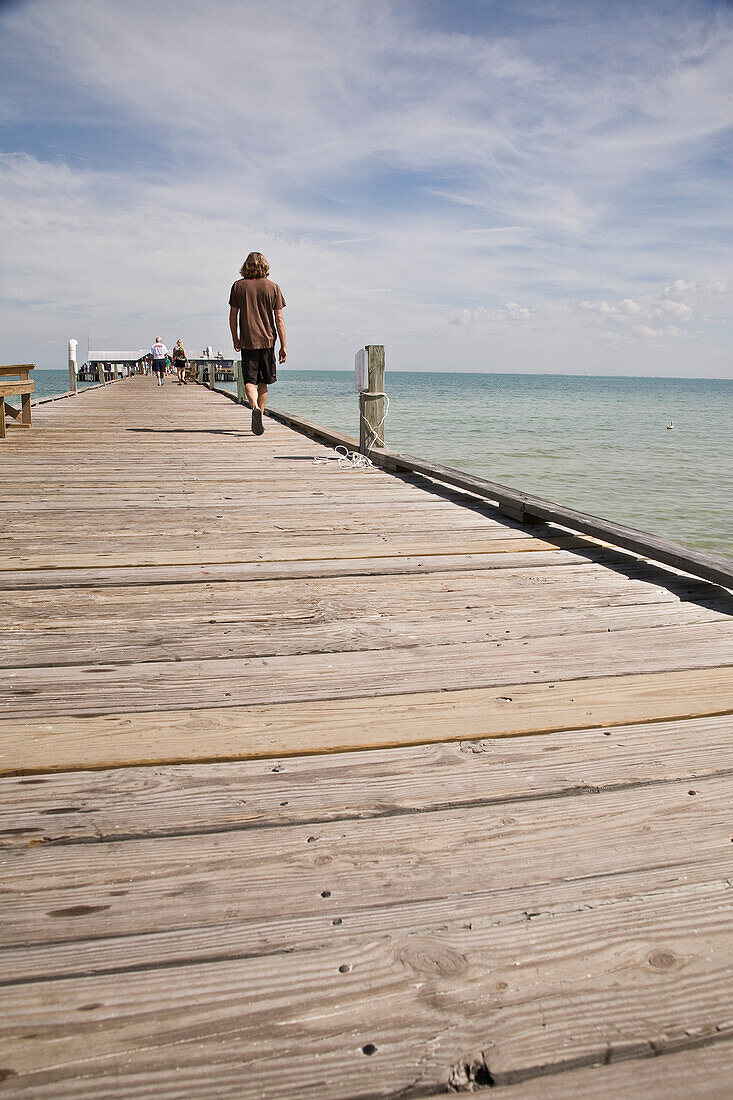 Man Walking On Anna Maria City Pier