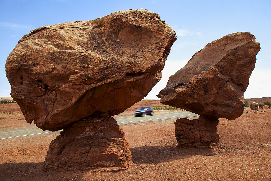 Geological Formation Known As 'balancing Rocks' Located Near Lee's Ferry, Az On Native American Land, As Seen In Mid-Summer With A Car Traveling On Highway And Blue Sky Beyond; Arizona, United States Of America