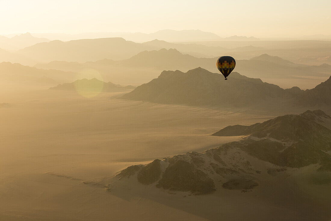 Hot air balloon ride over the sand dunes in the Namib Desert at sunrise; Sossusvlei, Hardap Region, Namibia