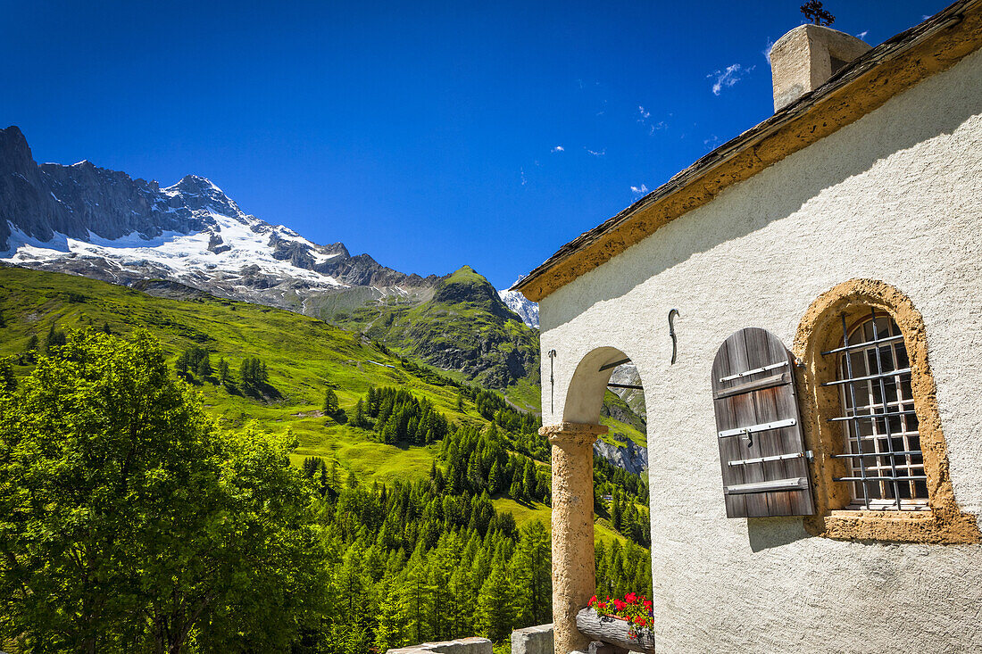 A small chapel at Ferret under blue sky; Ferret, Val Ferret, Switzerland