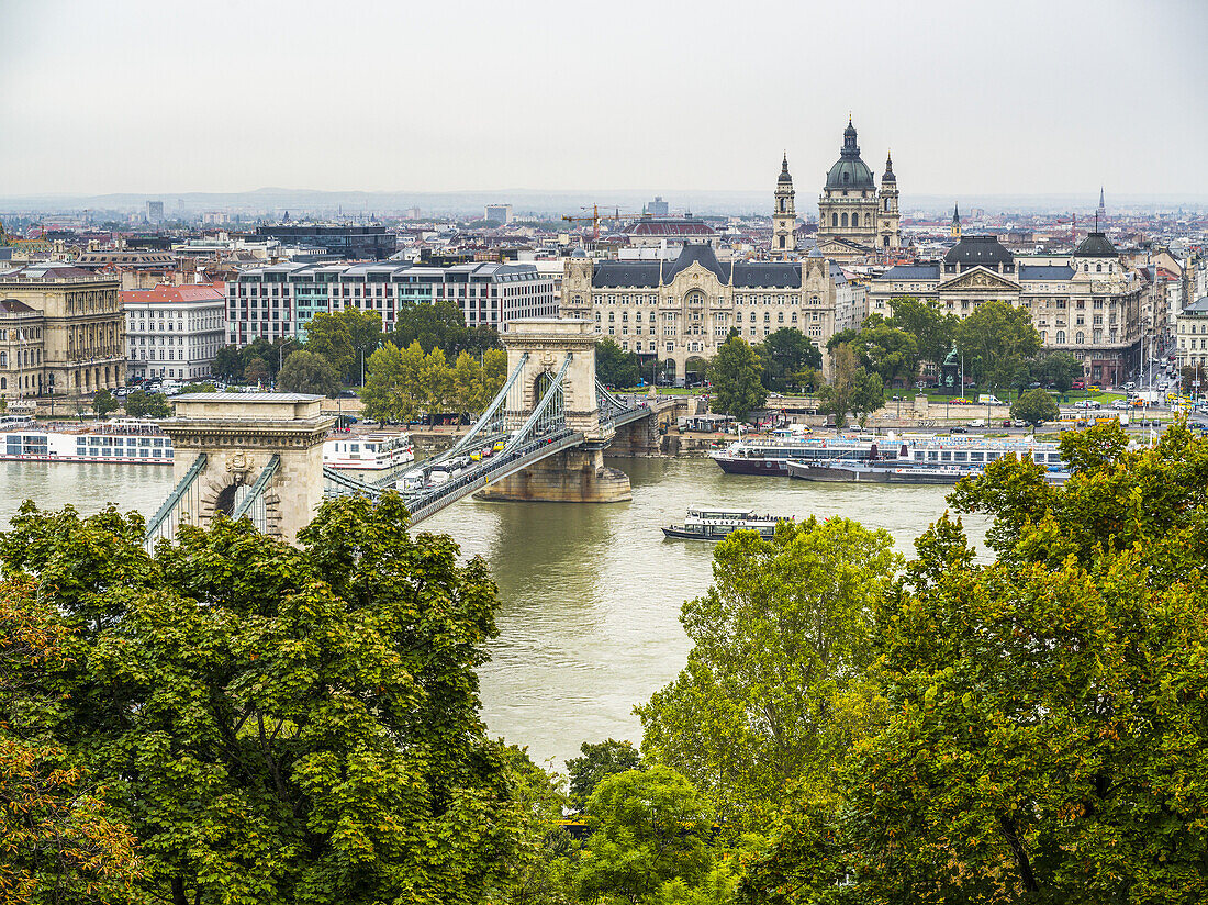 Boats on the Danube River and cityscape of Budapest; Budapest, Budapest, Hungary