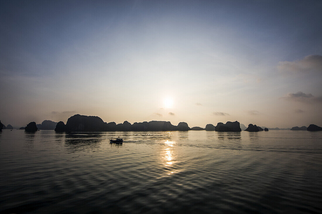Limestone karsts and isles of Ha Long Bay at sunset; Quang Ninh, Vietnam