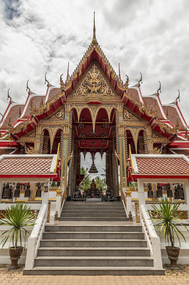 Red and gold temple with Buddha statue, Otop Temple; Bangkok, Thailand