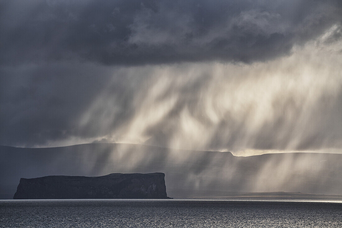 Dramatic light and clouds over the ocean along the North coast of Iceland; Hofsos, Iceland