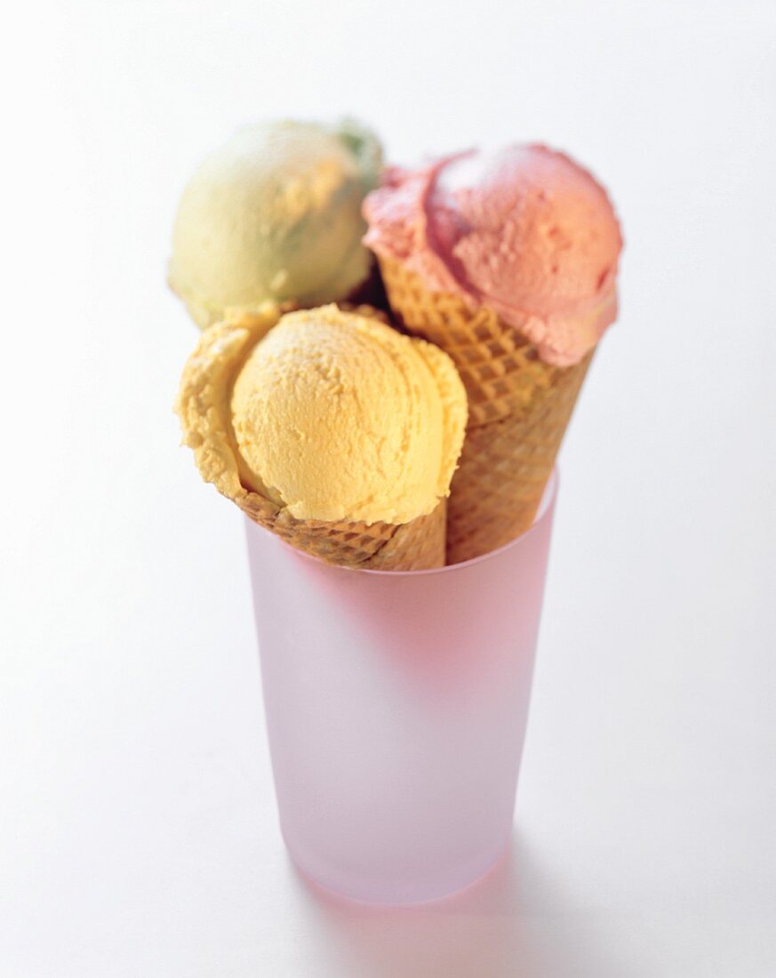 Three ice cream wafers with scoops of ice cream in a glass