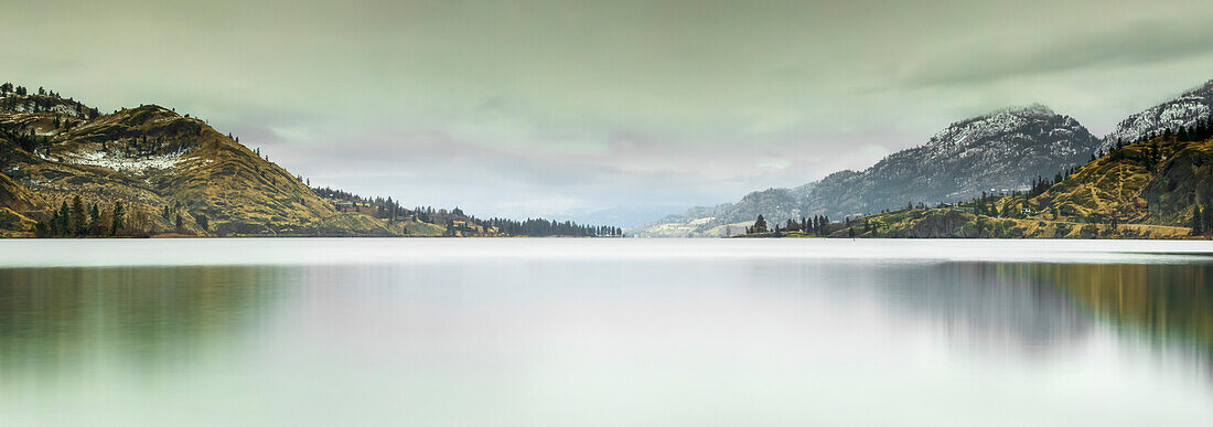 Large multi-stitch panorama of the Cascade Mountains and the Okanagan Valley in an autumn setting with early snow; British Columbia, Canada