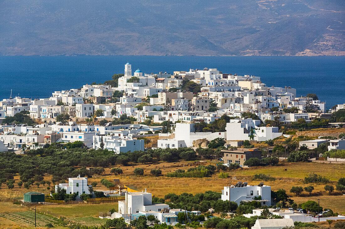 Town on the coast of Milos Island with white buildings and blue sea; Adamas, Milos Island, Cyclades, Greece