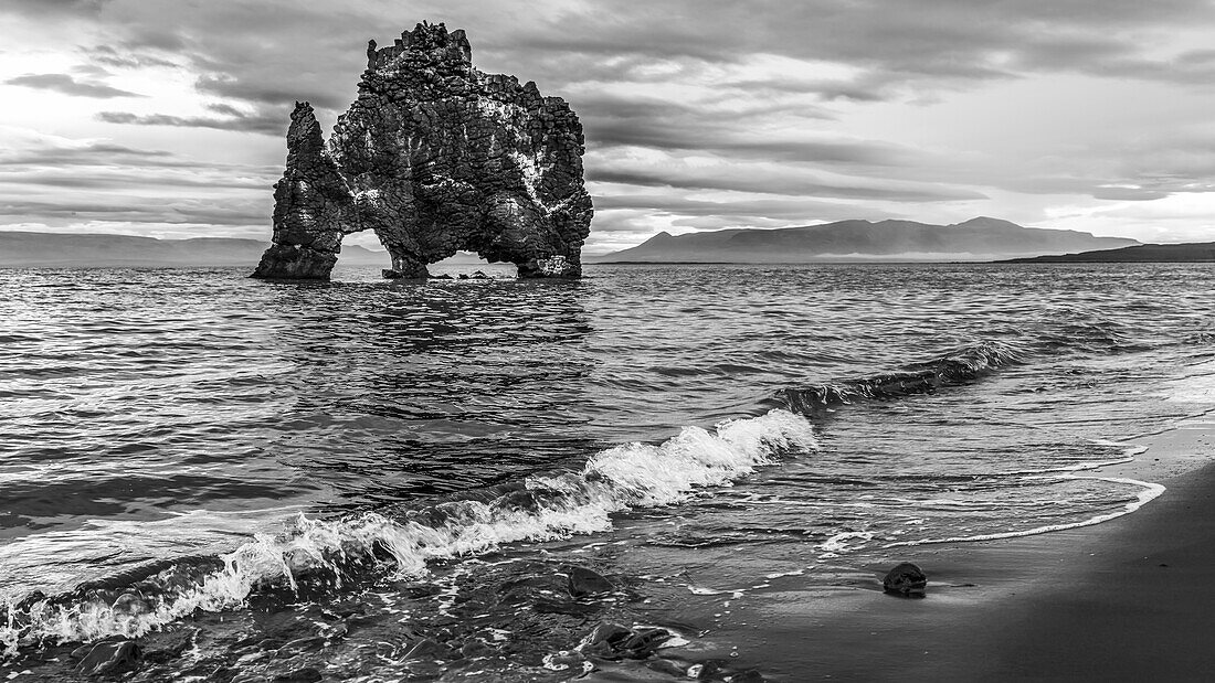 Hvitserkur is a 15 metre high basalt stack along the Eastern shore of the Vatnsnes peninsula, in Northwest Iceland. The rock has two holes at the base, which give it the appearance of a dragon who is drinking; Hunaping vestra, Northwestern Region, Iceland