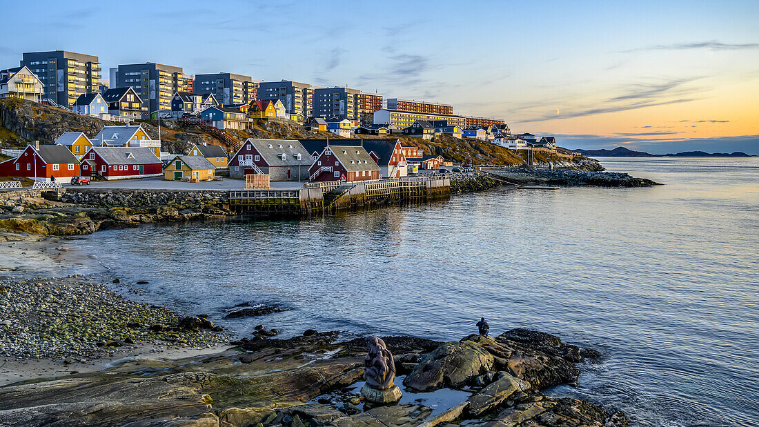 Colourful houses along the rocky shore of Nuuk at dusk; Nuuk, Sermersooq, Greenland