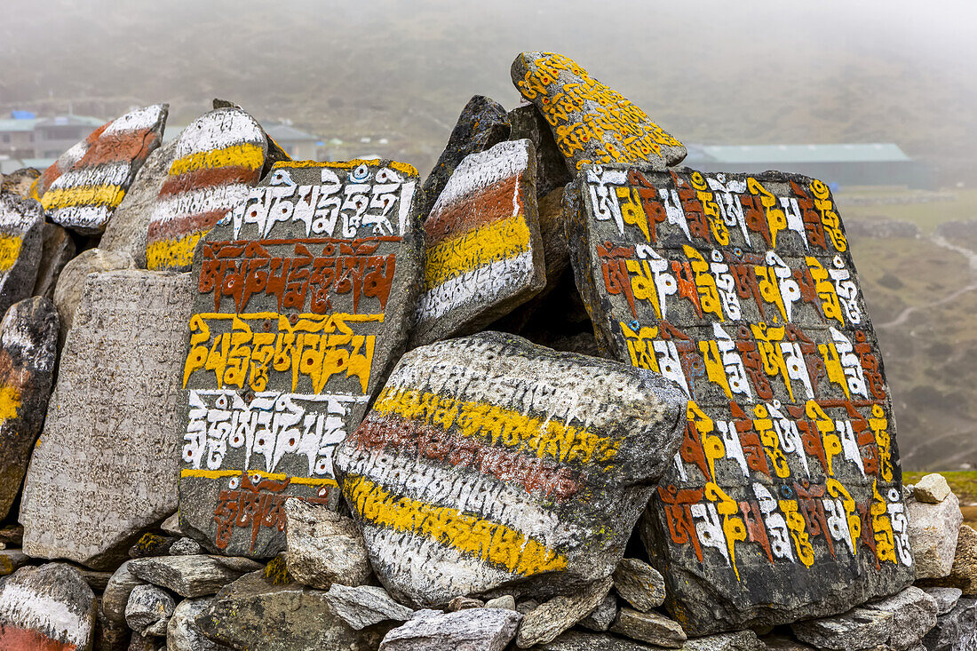 Colourful painted script on rocks; Nepal