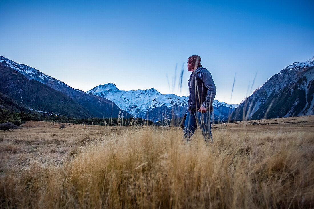 A man admires the beauty of Mount Cook National Park; Canterbury, New Zealand