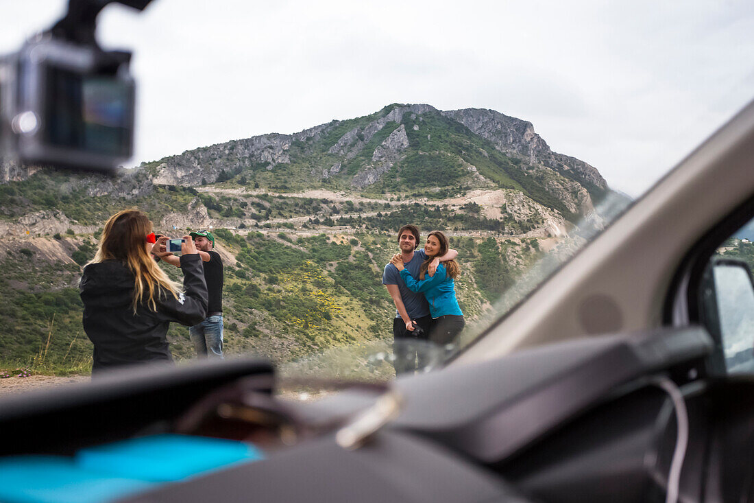 A group of travelers stop to take photographs along the Croatian coastline; Pisak, Split-Dalmatia County (Splitsko-dalmatinska zupanija), Croatia