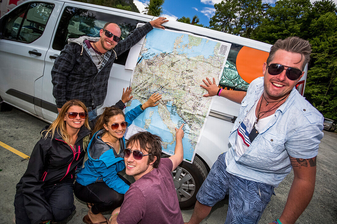 A group of travellers trace their trip on a map; Bled, Slovenia
