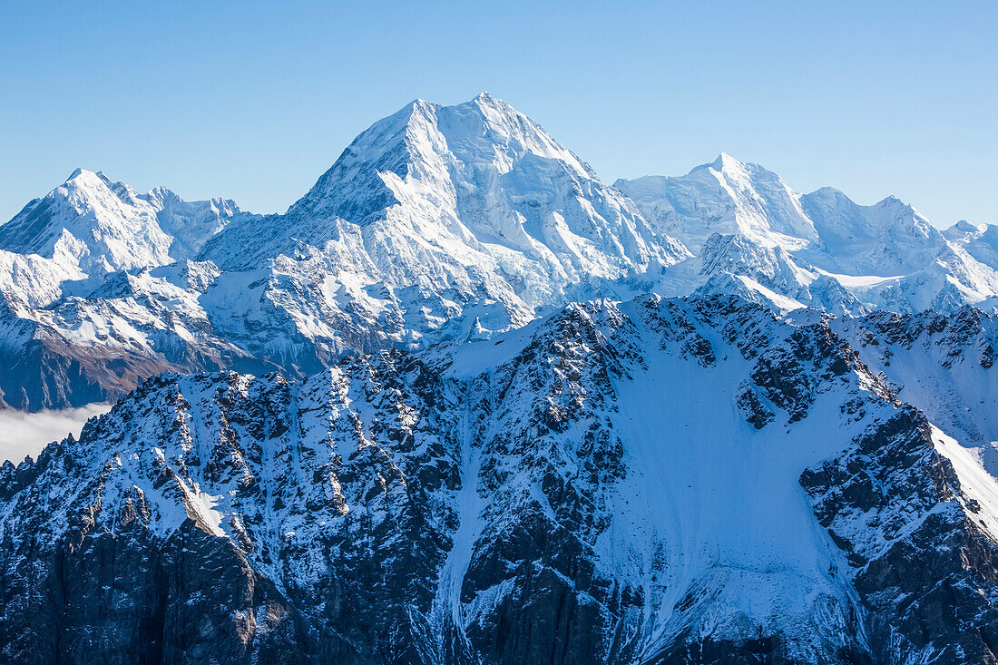 A helicopter tour provides stunning views over the Mt Cook Glacier and surrounding snow covered mountaintops; Mount Cook National Park, Canterbury, New Zealand