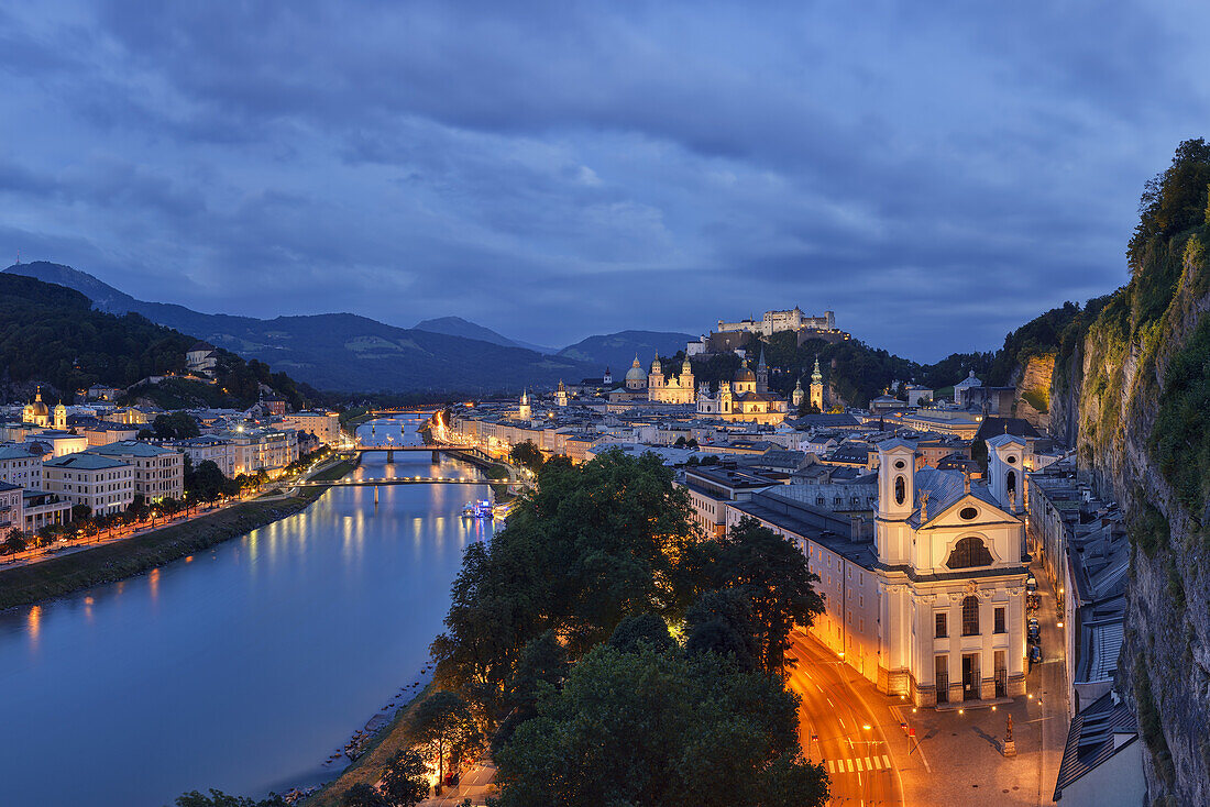 Scenic overview of the Salzach River and the historical city of Salzburg at nightfall; Salzburg, Salzburg, Austria