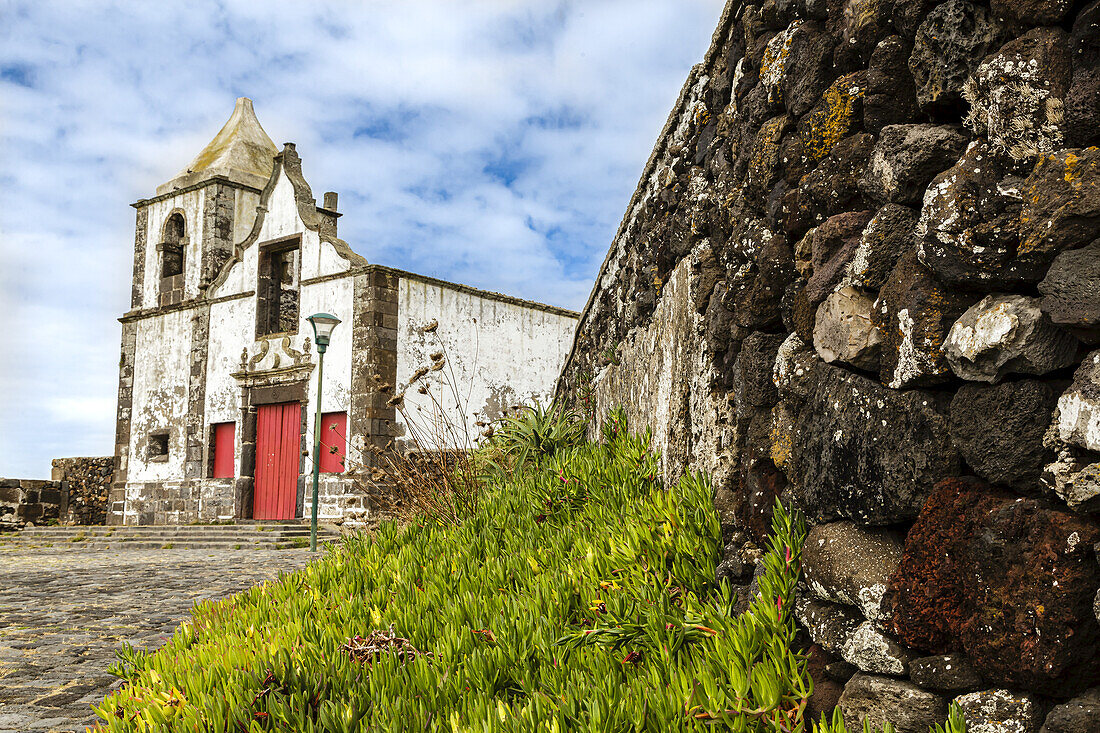 Old stone wall and the 16th century ruins of the Church of Sao Mateus da Calheta which was abandoned after being severely damaged in a hurricane in the 1800's; Angra do Heroismo, Terceira, Azores