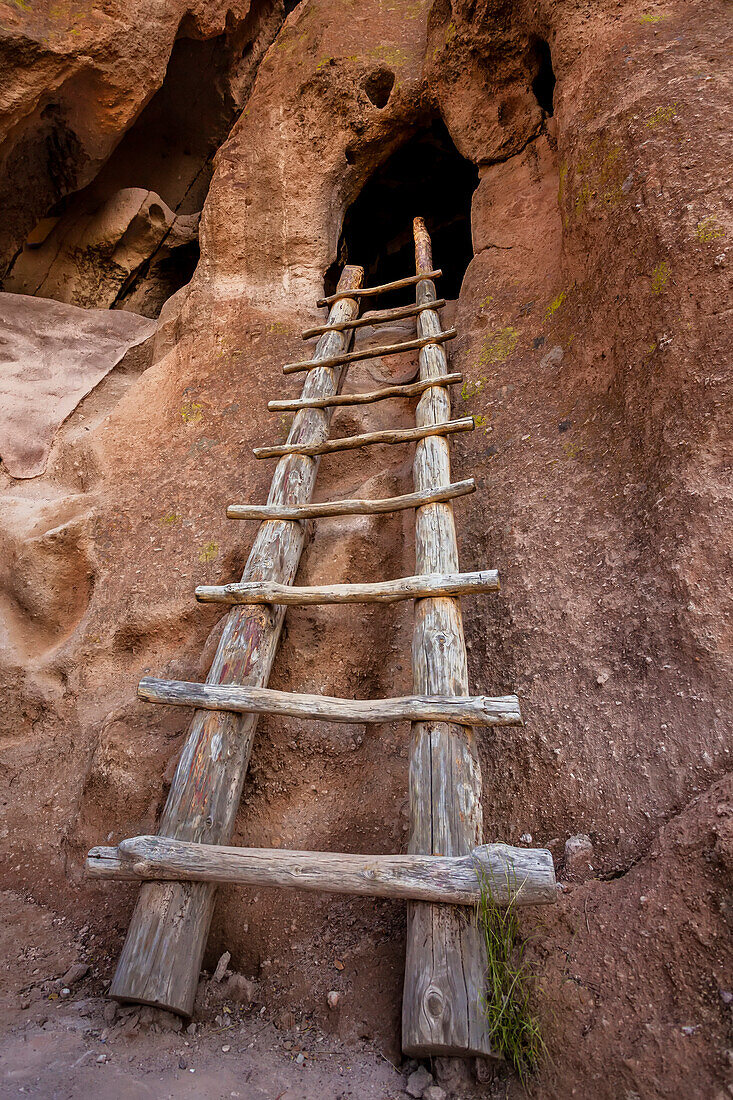 A wooden ladder in the Pueblo Ruins leads to a cave dwelling of the Ancestral Puebloans; Bandelier National Monument, New Mexico, United States of America