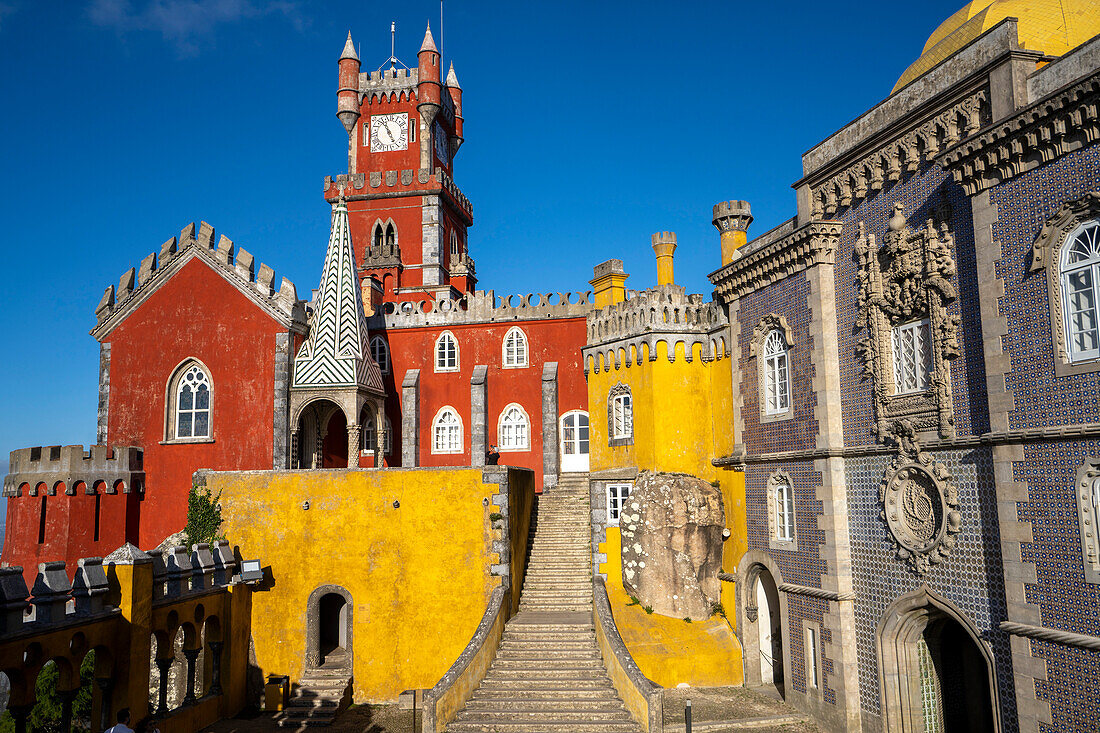 The hilltop castle of Palacio Da Pena with its colorful towers and stone staircase situated in the Sintra Mountains; Sintra, Lisbon District, Portugal