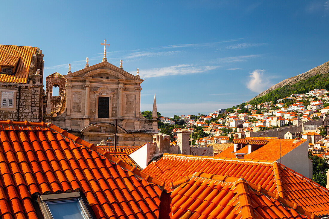 Overlooking the Old Town of the walled city of Dubrovnik, from terracotta tiled rooftops and the Church of St Ignatius to the coastal hillside covered in whitewashed houses; Dubrovnik, Dalmatia, Croatia