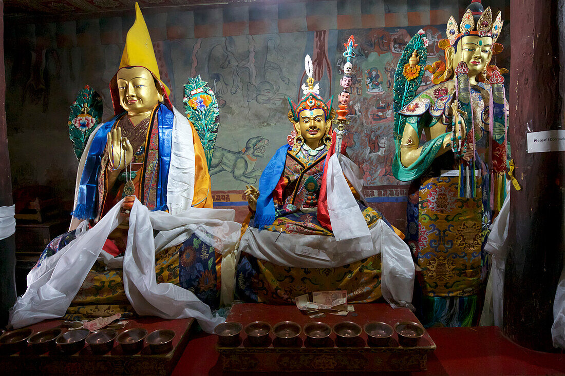 Statues representing Buddhist deities at the Prayer Hall inside the Thikse Monastery, on a mountaintop above the Indus Valley, through the Himalayan Mountains of Ladakh, Jammu and Kashmir; Thiksey, Ladakh, India