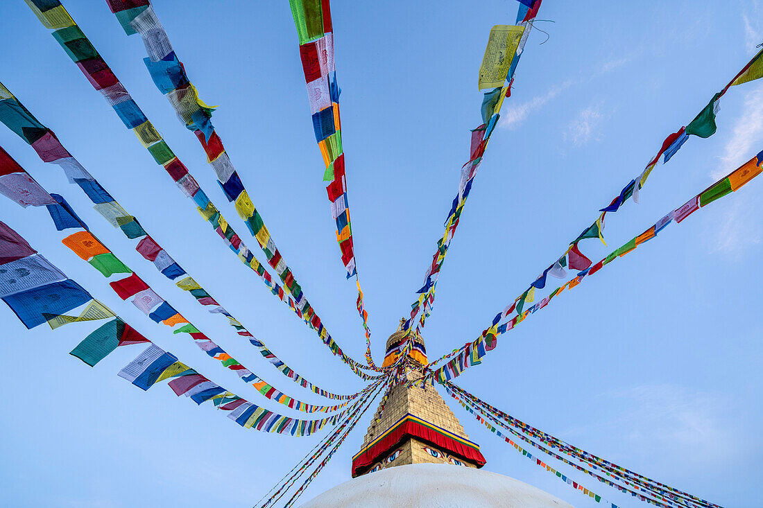 Prayer flags hanging from the spire of the largest Tibetan Buddhist stupa in Nepal at Boudhanath superb of Kathmandu; Kathmandu, Kathmandu, Nepal