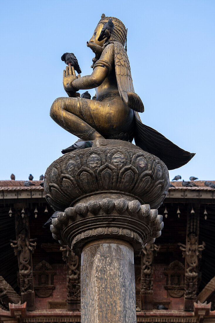 Column statue of Garuda at Durbar Square in the old city of Patan (or Lalitpur) built by the Newari Hindu Mallas between the 16th and 18th centuries in the Kathmandu Valley; Patan (Lalitpur), Kathmandu Valley, Nepal