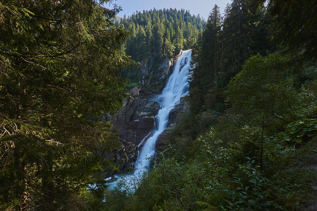 Krimml Waterfalls cascading down mountainside in the shade; Salzburg, Austria