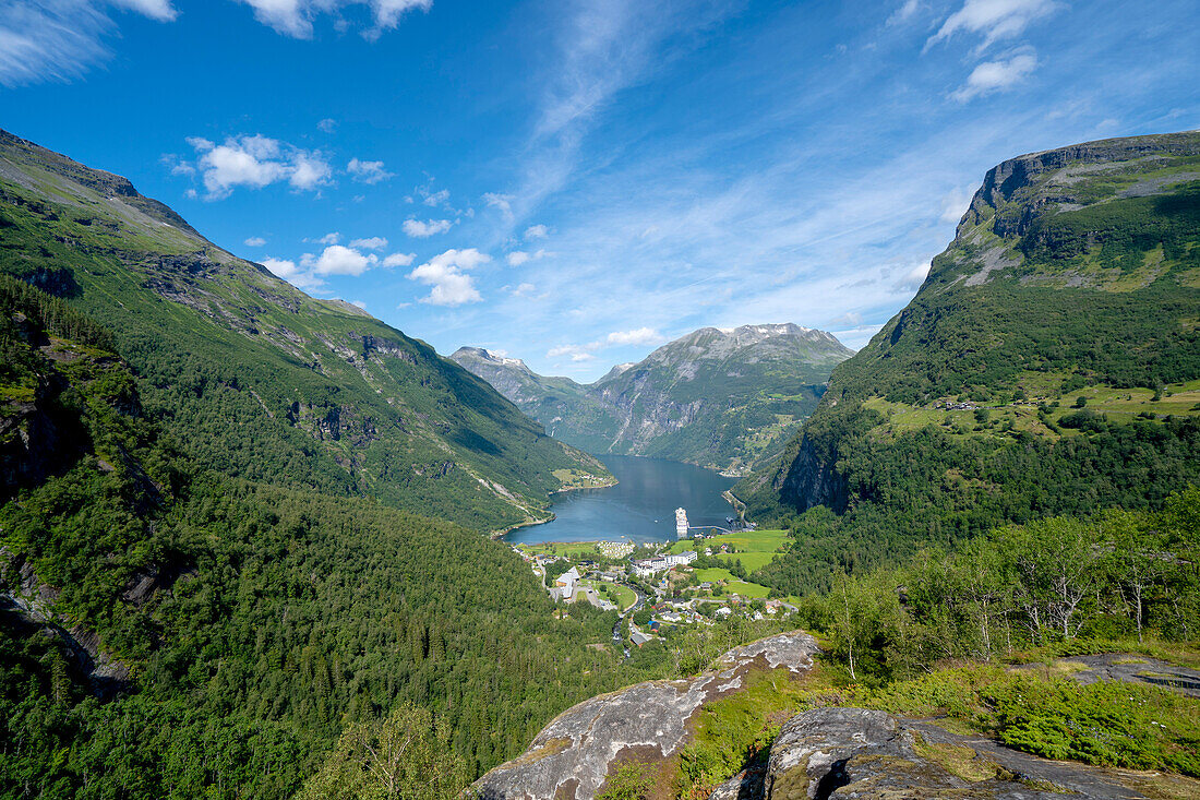 The tourist town of Geiranger surrounded by forested mountains at the head of the Geirangerfjord in Sunnmore; Geirangerfjord, Stranda, Norway