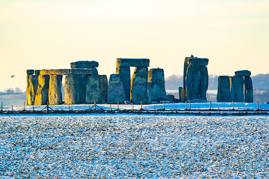 Stonehenge defined by early morning snow; Wiltshire, England, United Kingdom