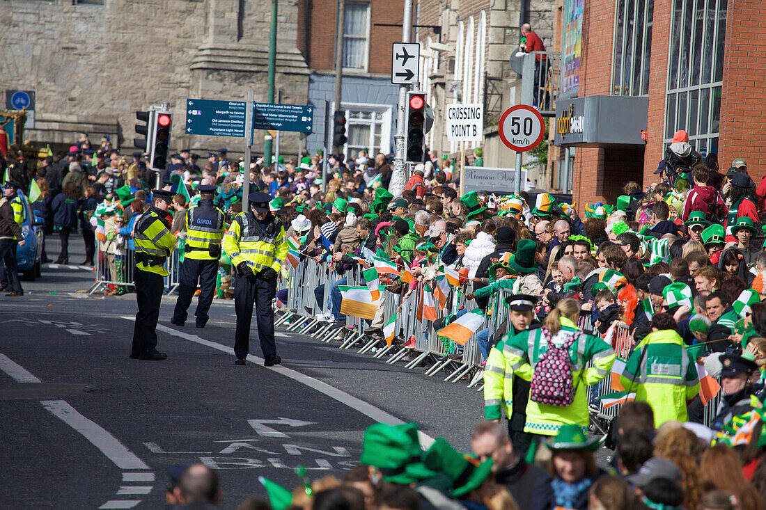 A Crowd And Police On The Street At The Saint Patrick's Day Parade; Dublin Ireland