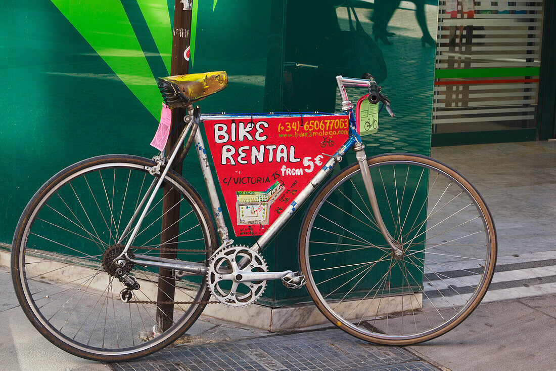 Bicycle Parked In Street Advertising Bike Rentals; Malaga Malaga Province Spain