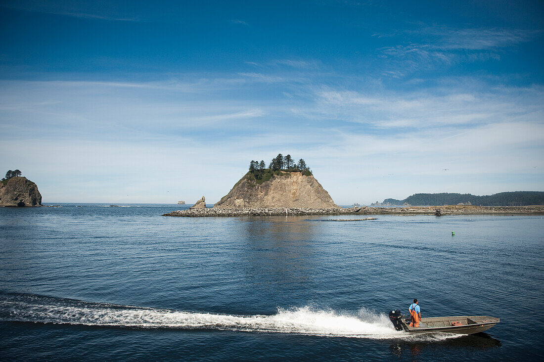 A Man Stands In A Motorboat And Drives Through Quileute River; La Push Washington United States Of America