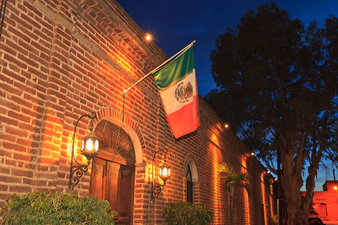 The Mexican Flag Hangs Above The Doorway Of A Building Downtown; Todos Santos Baja California Sur Mexico