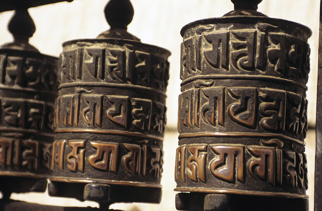 Nepal, Swayambhunath Temple; Kathmandu, Close-up of prayer wheels with carvings