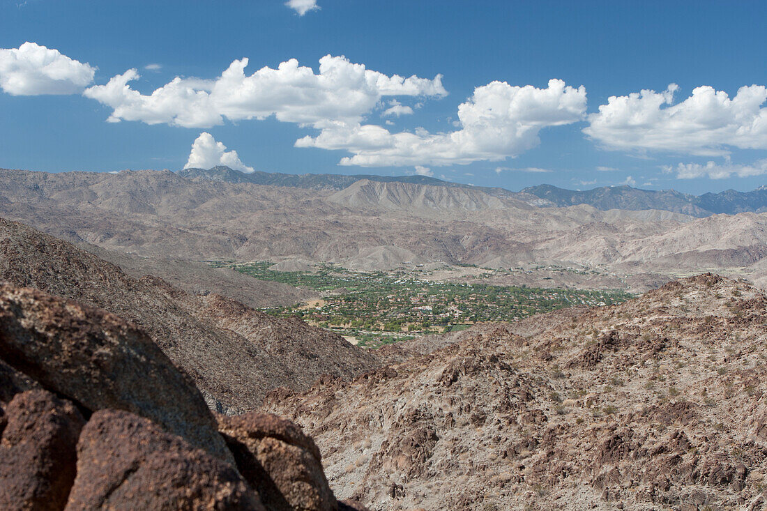 Desert Mountain Landscape And Green Valley Below With Blue Sky And Clouds; Palm Springs California United States Of America