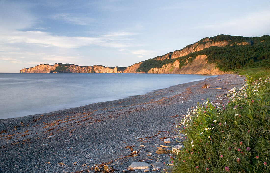 Sunrise On A Beach And Cliffs Along The Water; Quebec Canada