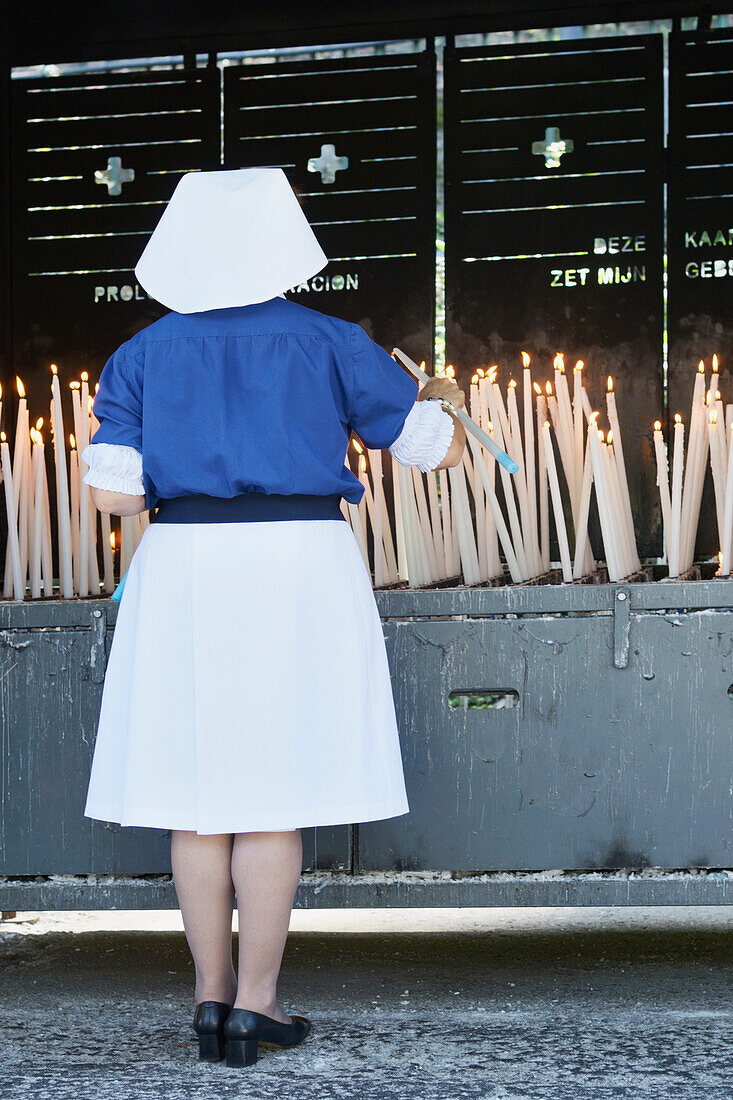 Nun Lighting A Blessed Candle Sanctuary Of Our Lady Of Lourdes; Lourdes Hautes-Pyrenees France