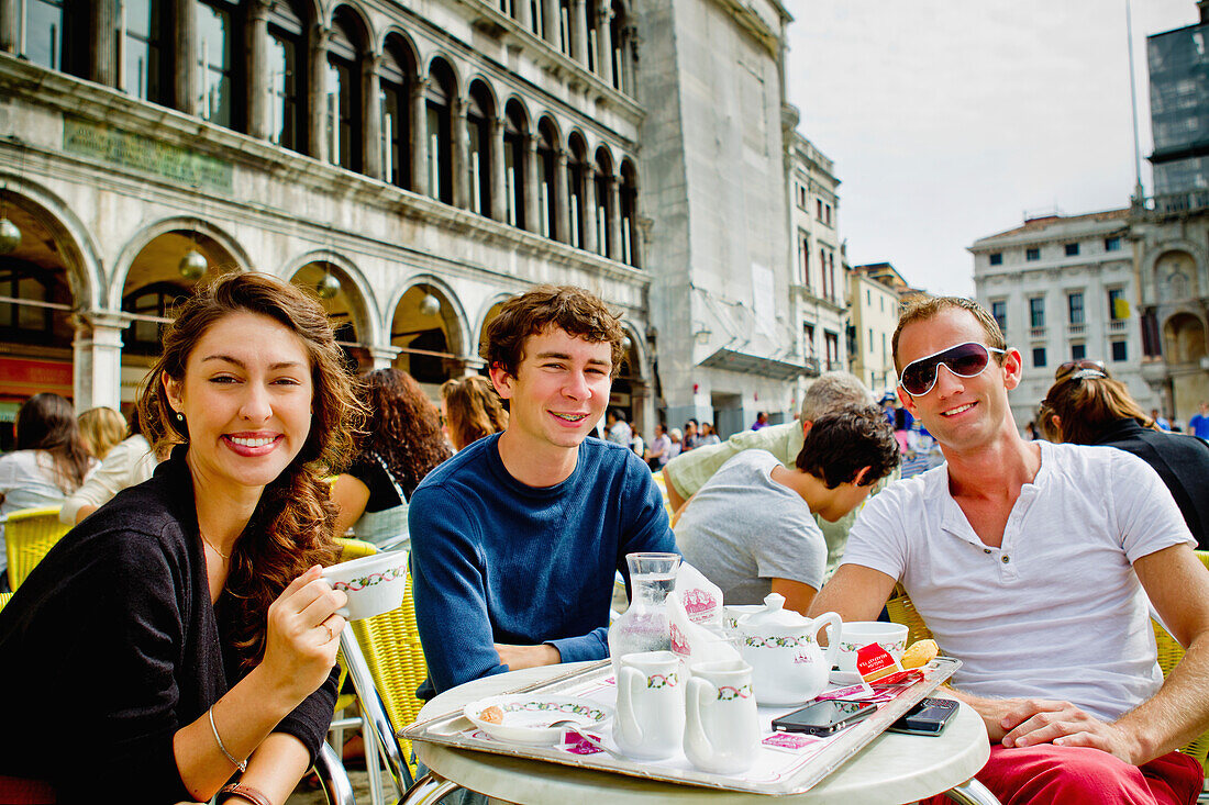 Friends Enjoying Coffee On Saint Mark's Square; Venice Italy