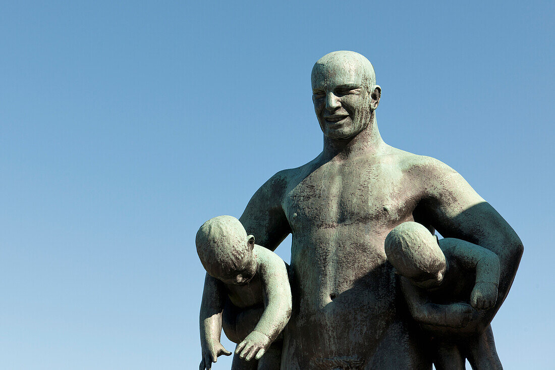 Sculpture Of A Father Holding Two Children In Frogner Park Vigeland Sculpture Park; Oslo Norway