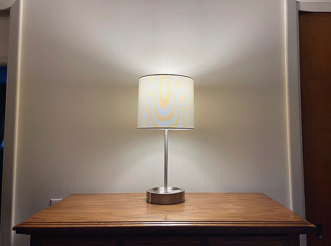 Illuminated Table Lamp on Wood Dresser
