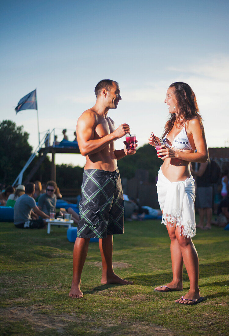 A Young Man And Young Woman Talking At A Beach Bar; Tarifa Cadiz Andalusia Spain