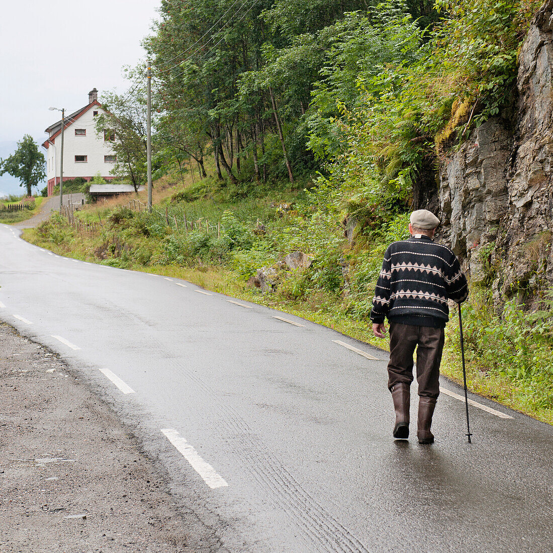 An Elderly Man Walks Up The Road; Hardangervidda Norway