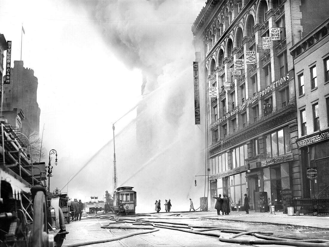 Fireman spraying water on burning building, 14th Street, New York City, New York, USA, Bain News Service, December 1909
