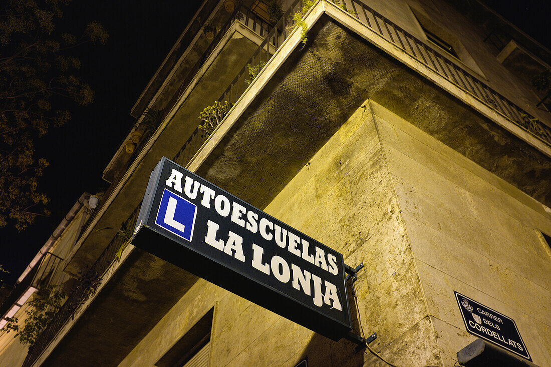 Low Angle View of Driving School Sign on Corner of Building at Night, Valencia, Spain