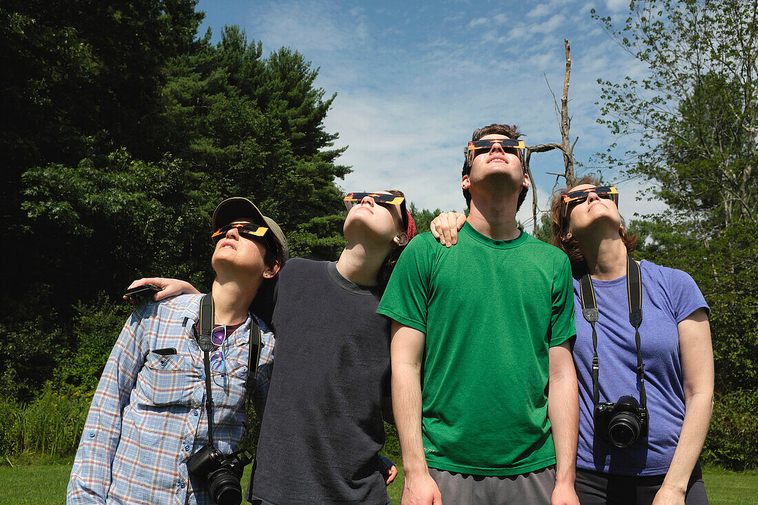 Small Group of People wearing Eclipse Glasses while viewing Partial Solar Eclipse