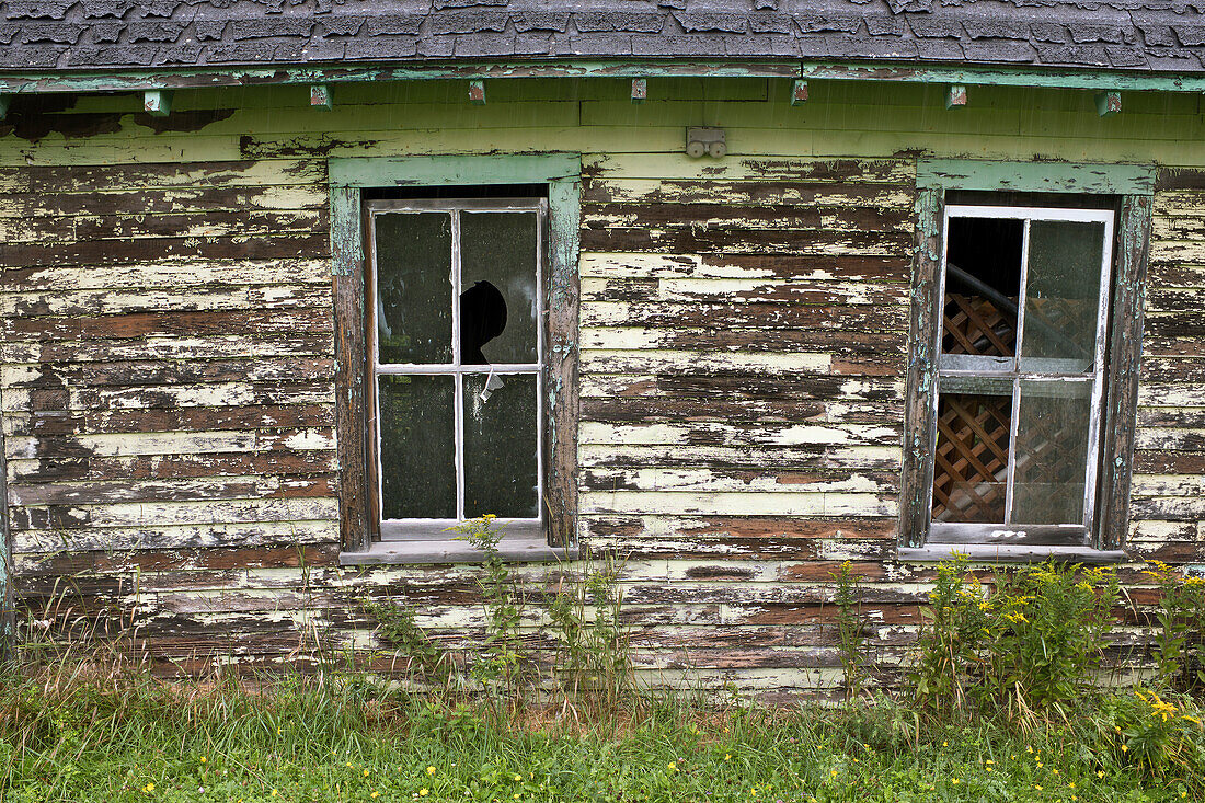 Old Barn with Two Broken Windows and Peeling Paint